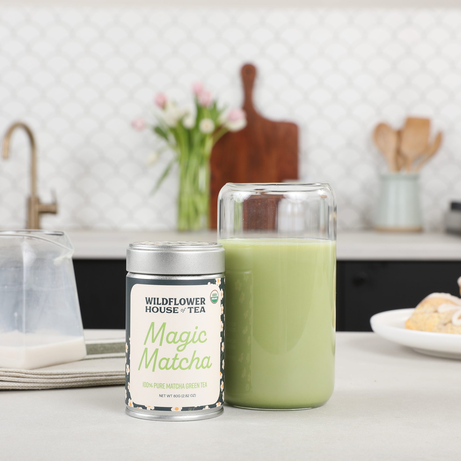 Matcha container next to a glass of matcha latte